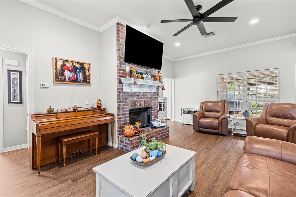 10616 Whitney Trace Drive Waco, TX 76708 - Photo 9 of 37 a living room with furniture a fireplace and a flat screen tv