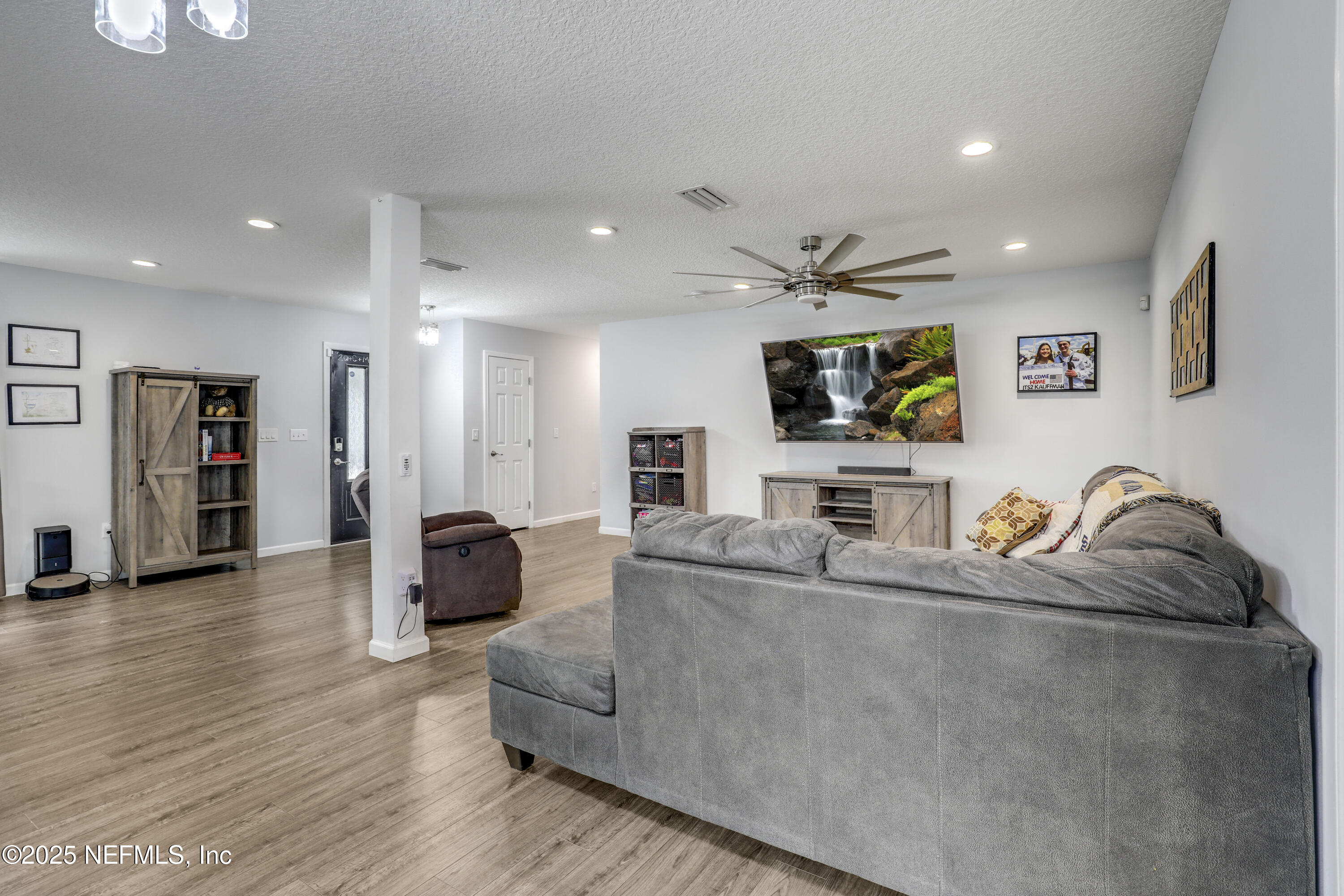 11265 Beacon Drive Jacksonville, FL 32225 - Photo 17 of 62 a living room with furniture and a flat screen tv