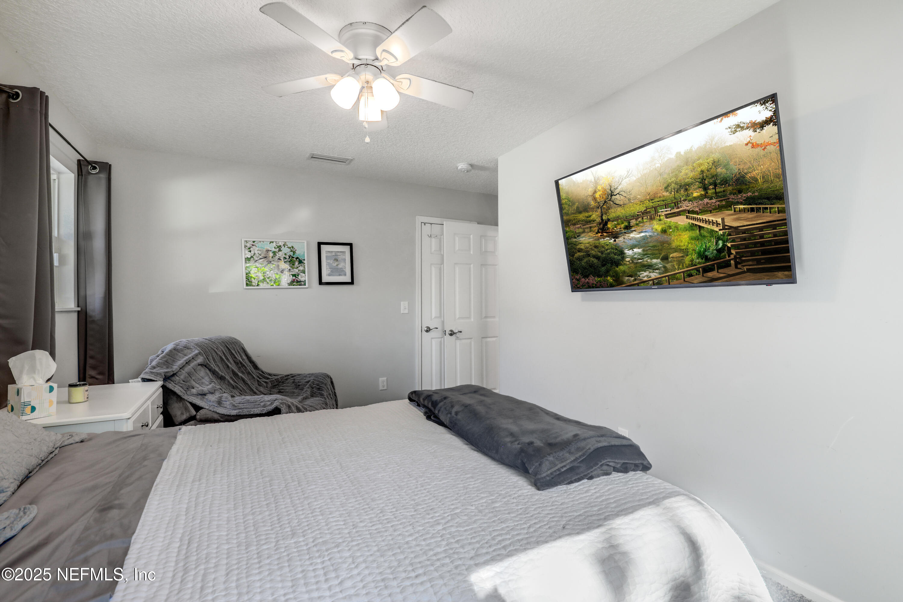 11265 Beacon Drive Jacksonville, FL 32225 - Photo 36 of 62 a bedroom with a bed and a painting on the wall