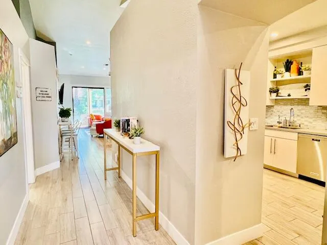 a kitchen with stainless steel appliances cabinets and wooden floor