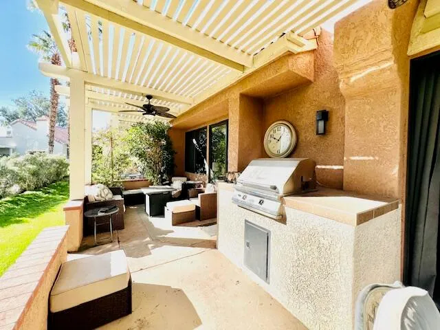 a living room with patio furniture and a large window