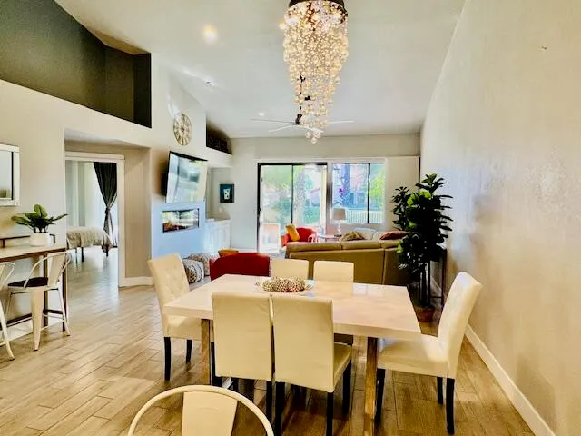 a view of a dining room with furniture wooden floor and chandelier