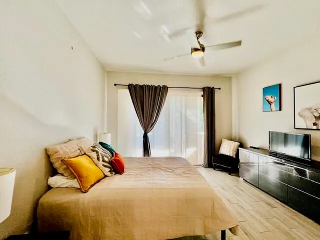 a bedroom with a bed and a television