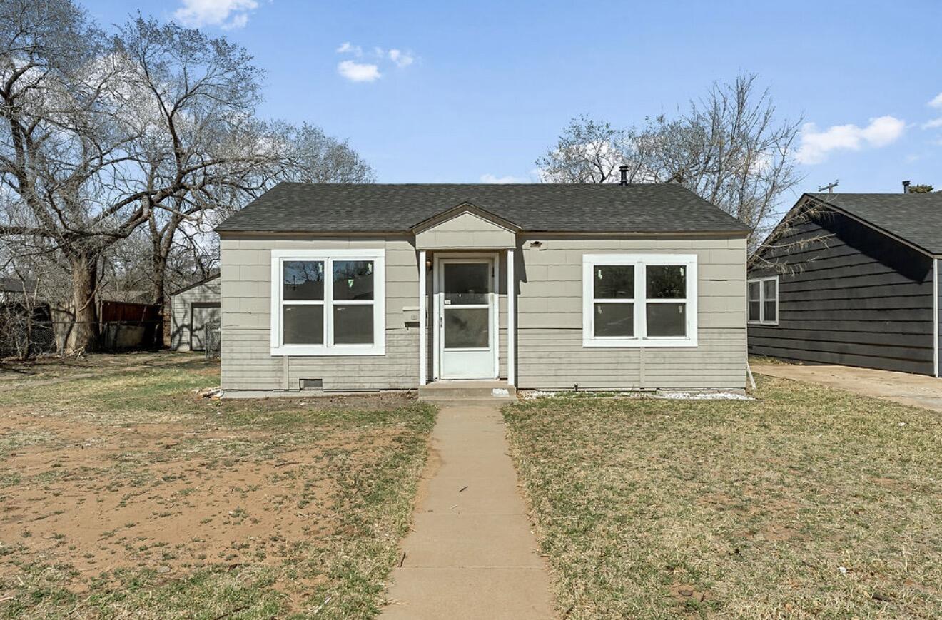 2814 40th Street Lubbock, TX 79413 - Photo 2 of 11 a front view of a house with a garden