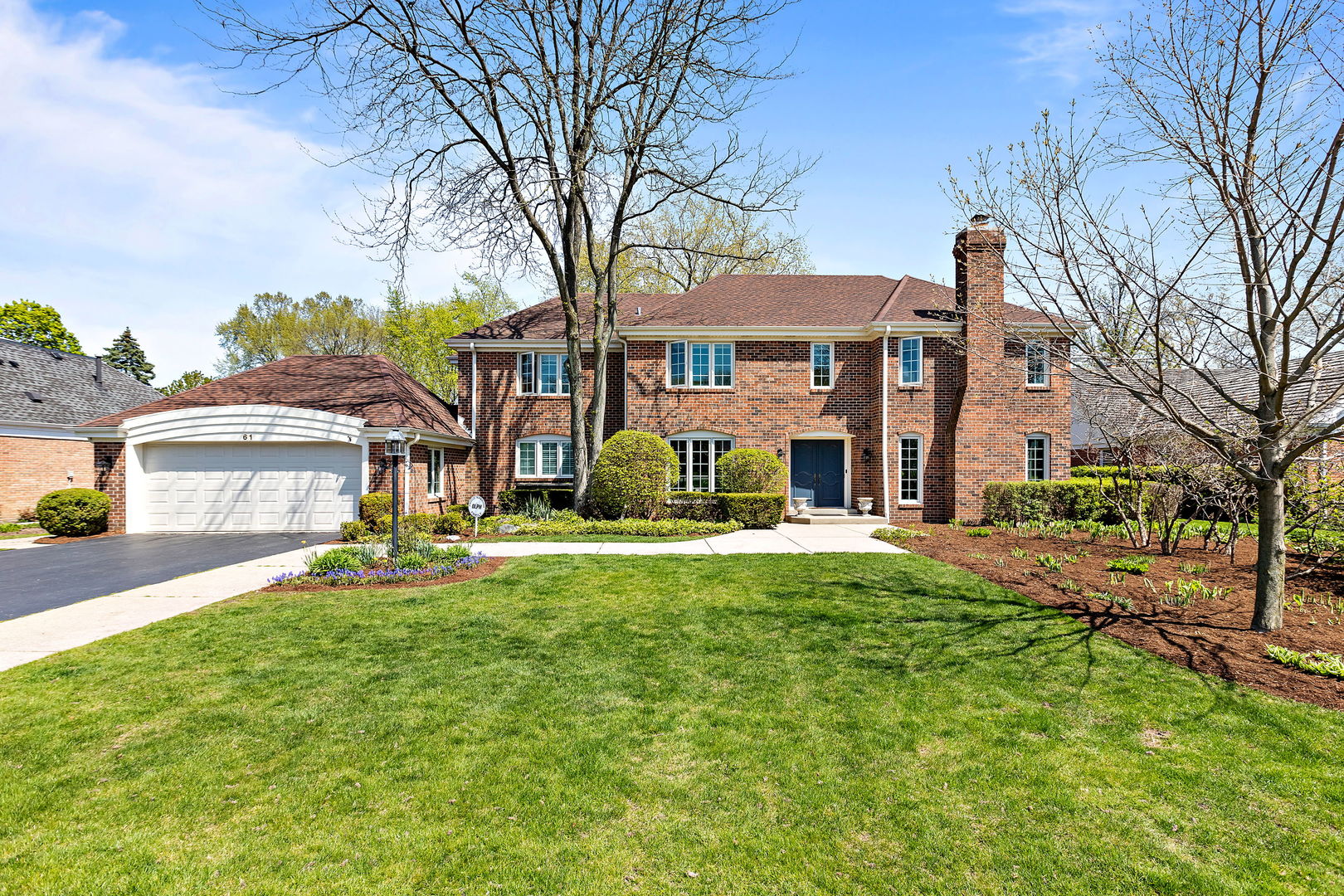 a view of a house with a yard and tree s