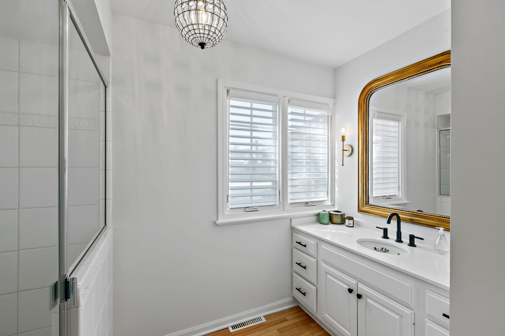 61 Coventry Road Northfield, IL 60093 - Photo 12 of 28 a bathroom with a double vanity sink a mirror and a bathtub