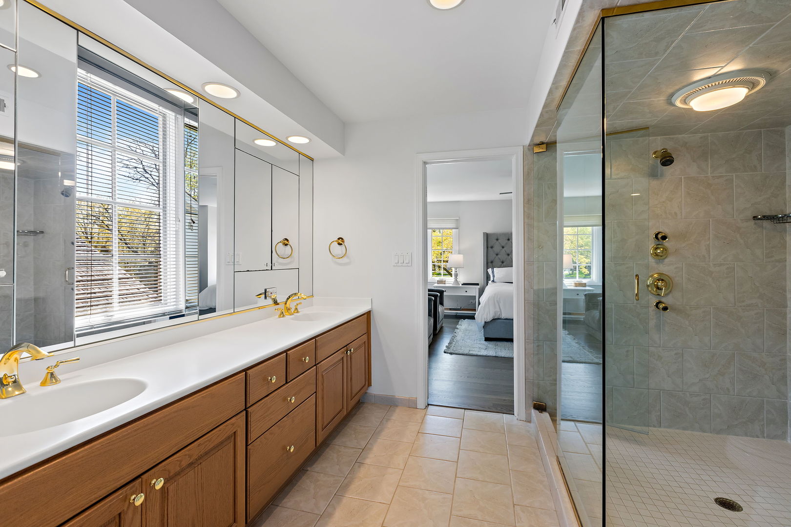 61 Coventry Road Northfield, IL 60093 - Photo 15 of 28 a spacious en suite bathroom with a double vanity sink a large mirror and a shower