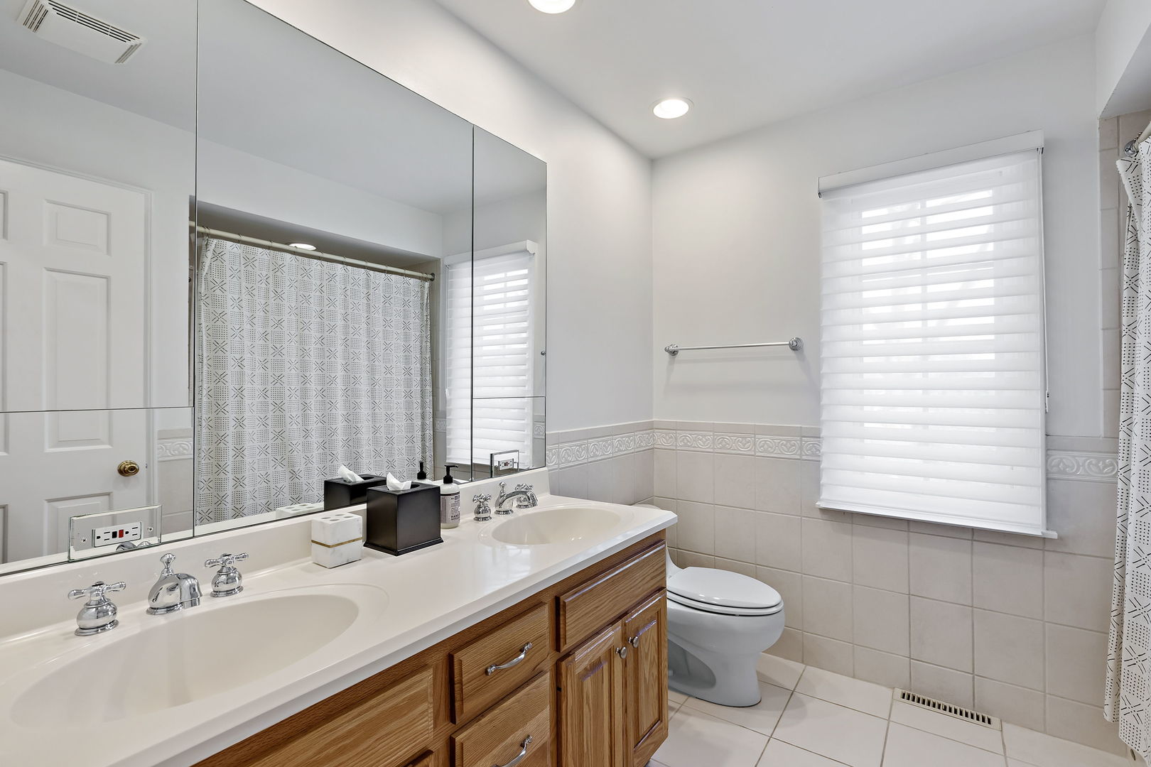 61 Coventry Road Northfield, IL 60093 - Photo 21 of 28 a bathroom with a granite countertop sink toilet a large mirror and shower