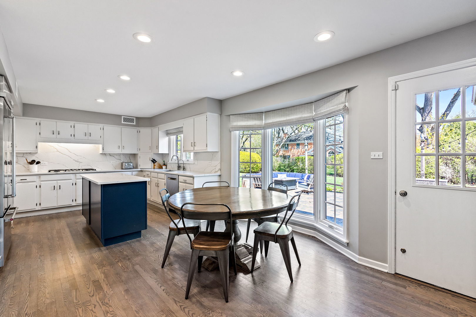 61 Coventry Road Northfield, IL 60093 - Photo 7 of 28 a kitchen with a table chairs sink and cabinets