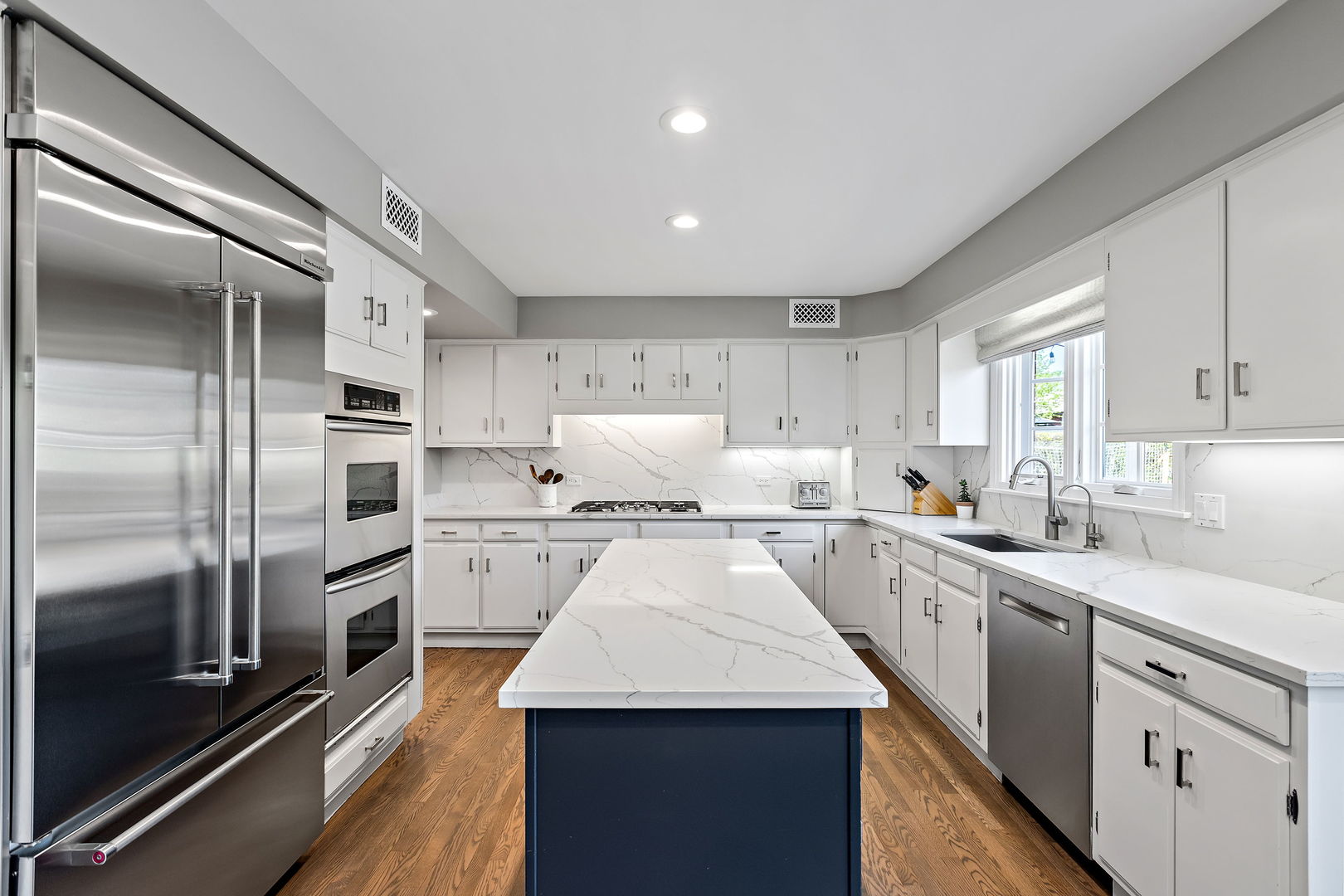 61 Coventry Road Northfield, IL 60093 - Photo 9 of 28 a kitchen with stainless steel appliances granite countertop a sink a stove and refrigerator