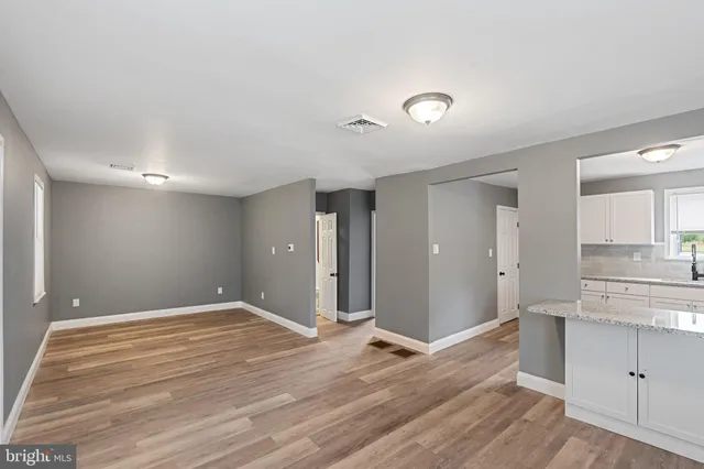 a view of a kitchen with wooden floor and a sink