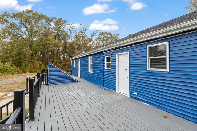 a view of deck with wooden floor and fence with a garden