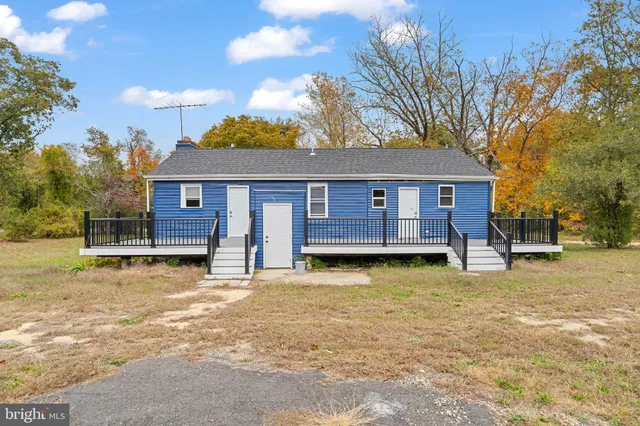 a view of a house with a swimming pool and a tree