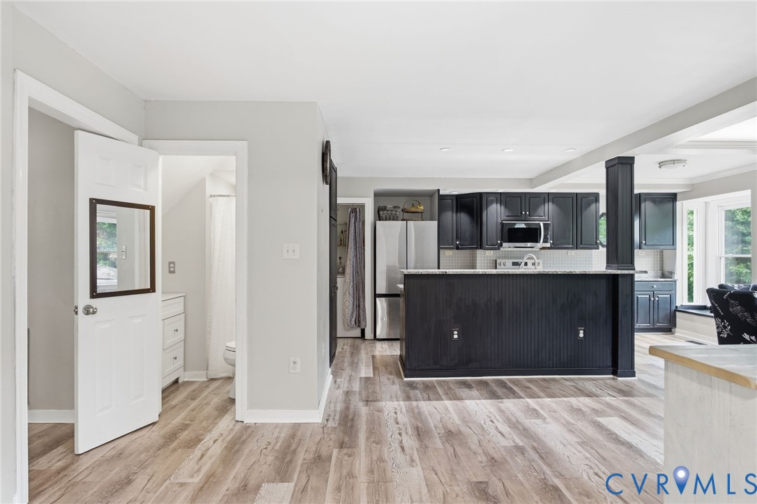 9110 Gayton Road Henrico, VA 23229 - Photo 8 of 54 a living room with stainless steel appliances kitchen island furniture and wooden floor