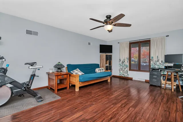 a living room with furniture and a wooden floor