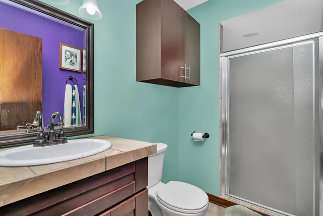 a bathroom with a sink a toilet and mirror