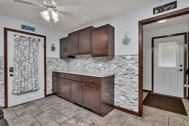 a kitchen with stainless steel appliances granite countertop a refrigerator and a sink