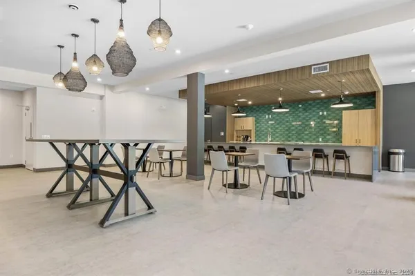 a view of a chairs and chandelier in a room