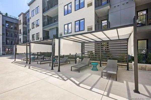 a view of a swimming pool and lounge chairs on th terrace