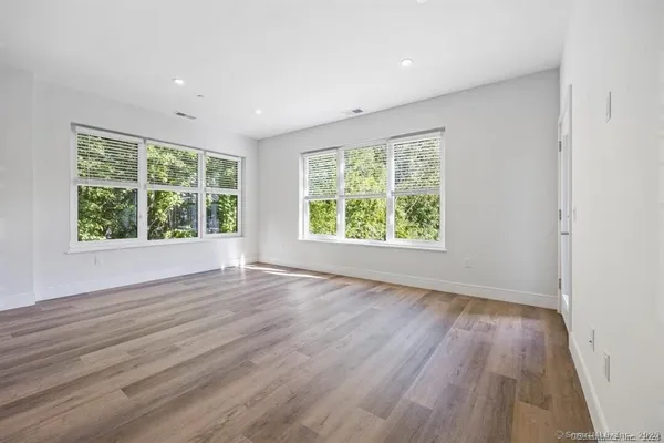 a view of kitchen with wooden floor and electronic appliances