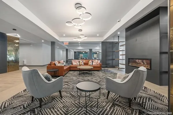 a living room with furniture and a chandelier
