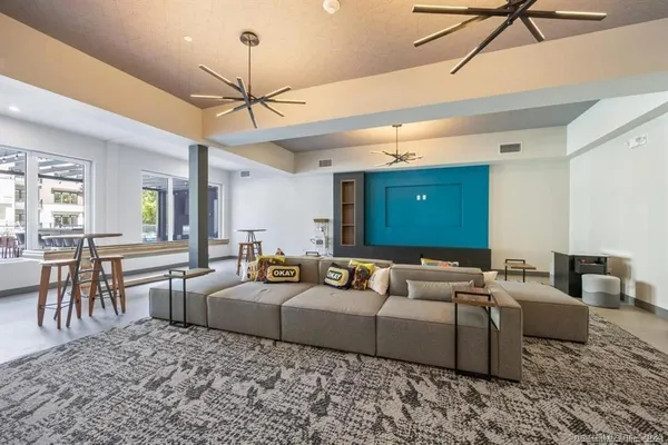 a view of a dining room with furniture and a chandelier