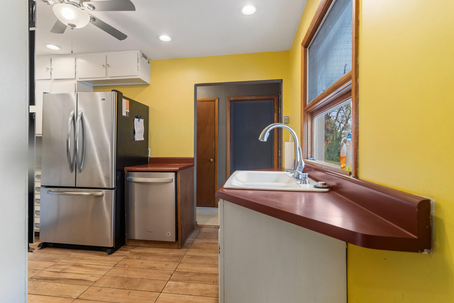 1405 Mayfair Road Champaign, IL 61821 - Photo 12 of 34 a kitchen with stainless steel appliances granite countertop a sink refrigerator and microwave