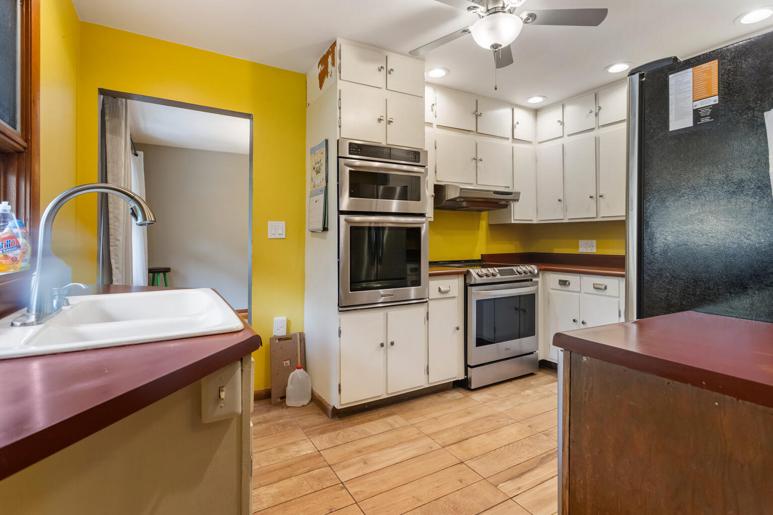 1405 Mayfair Road Champaign, IL 61821 - Photo 15 of 34 a kitchen with stainless steel appliances a stove a sink and white cabinets