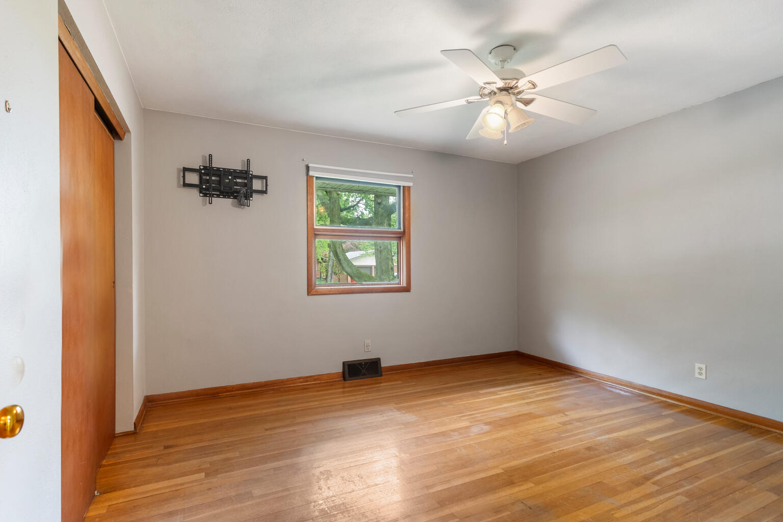 1405 Mayfair Road Champaign, IL 61821 - Photo 21 of 34 wooden floor in an empty room with a window