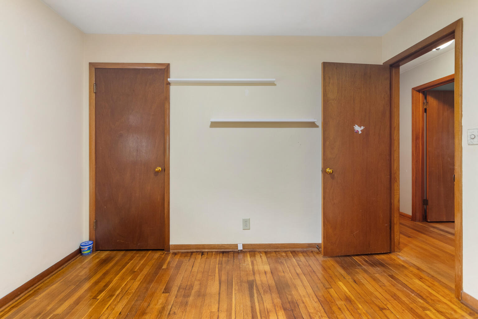1405 Mayfair Road Champaign, IL 61821 - Photo 24 of 34 a view of an empty room with wooden floor and a door