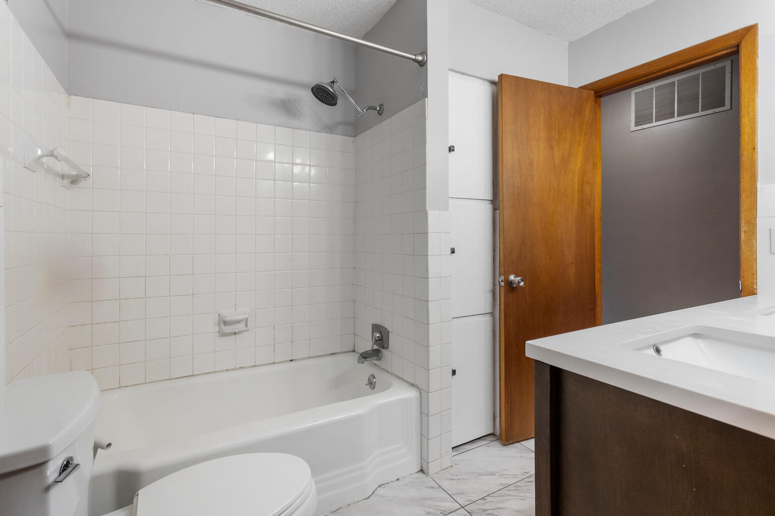 1405 Mayfair Road Champaign, IL 61821 - Photo 26 of 34 a bathroom with a bathtub shower sink vanity and toilet