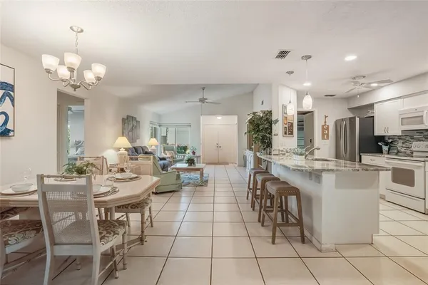 a large kitchen with a table and chairs