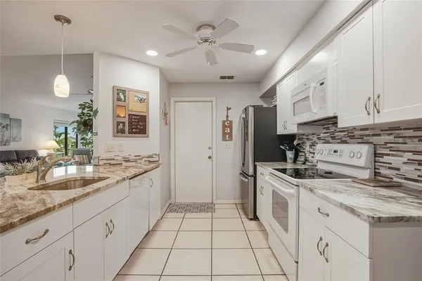 a kitchen with stainless steel appliances granite countertop a sink and cabinets