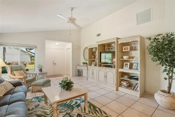 a living room with furniture a dining table and chairs with wooden floor
