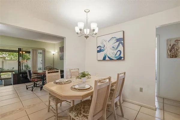 a view of a dining room with furniture and a chandelier