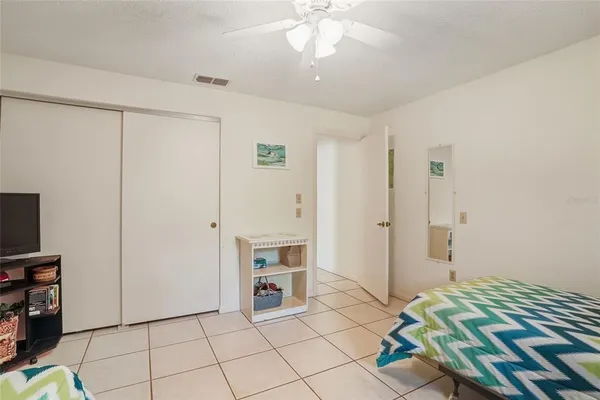 a bedroom with a bed and a television