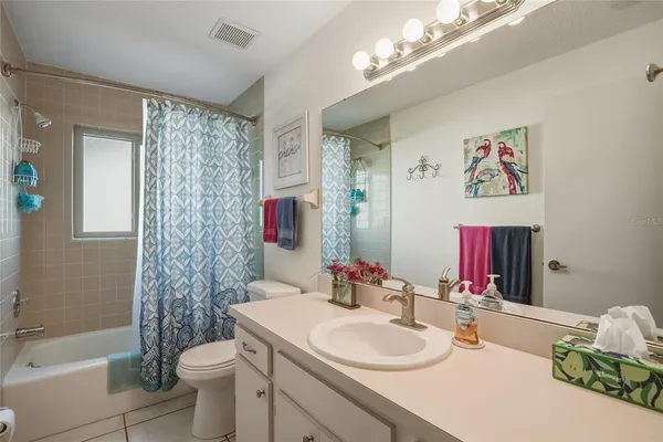 a bathroom with a sink vanity granite toilet tub and shower