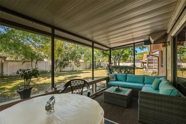 a living room with furniture and floor to ceiling windows