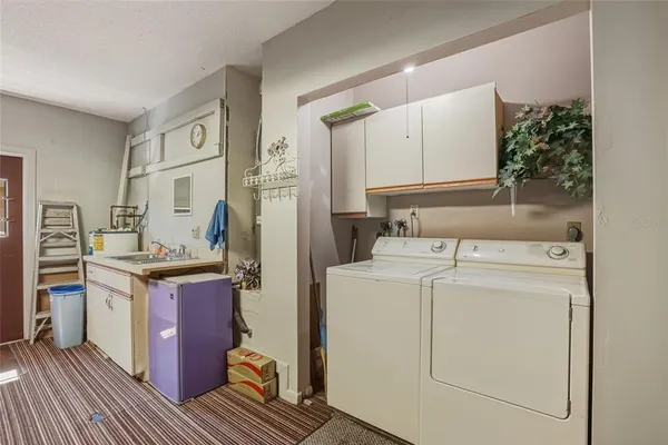a view of kitchen cabinets and refrigerator