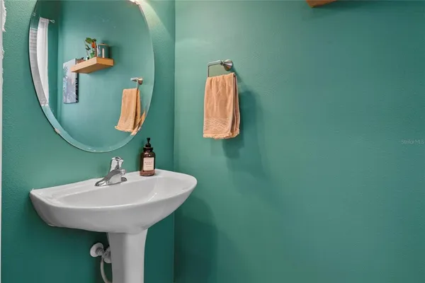 a bathroom with a sink and mirror