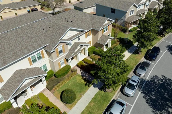 an aerial view of a house with yard
