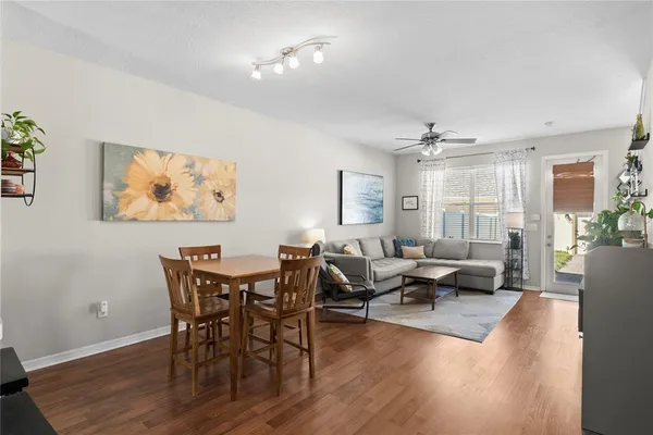 a view of a dining room with furniture window and wooden floor