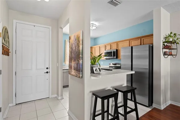 a kitchen with stainless steel appliances a refrigerator and microwave