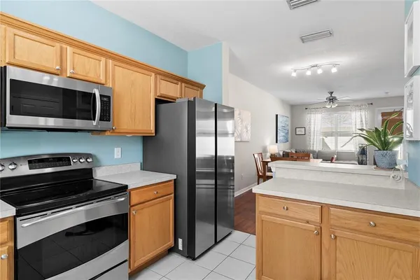 a kitchen with stainless steel appliances a stove microwave and refrigerator