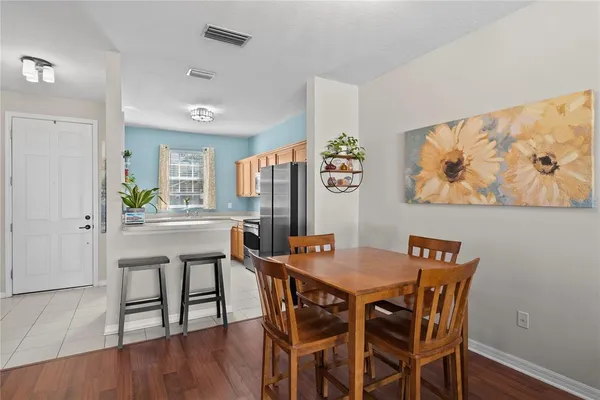 a view of a dining room with furniture and wooden floor