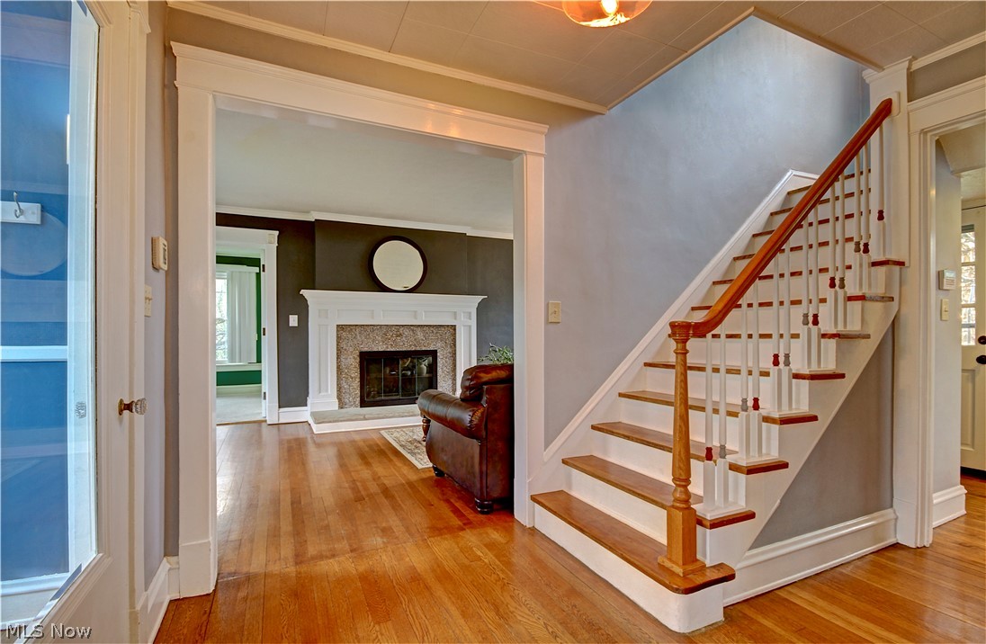 3054 Somerton Road Cleveland, OH 44118 - Photo 5 of 40 Stairway with ornamental molding and light hardwood / wood-style flooring