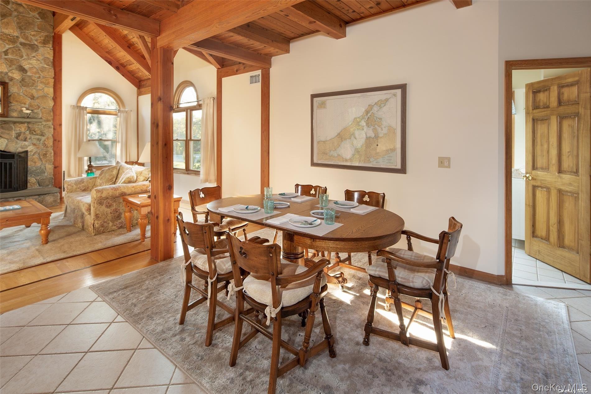 48 Oakhurst Road Hampton Bays, NY 11946 - Photo 13 of 25 a dining room with furniture and large windows