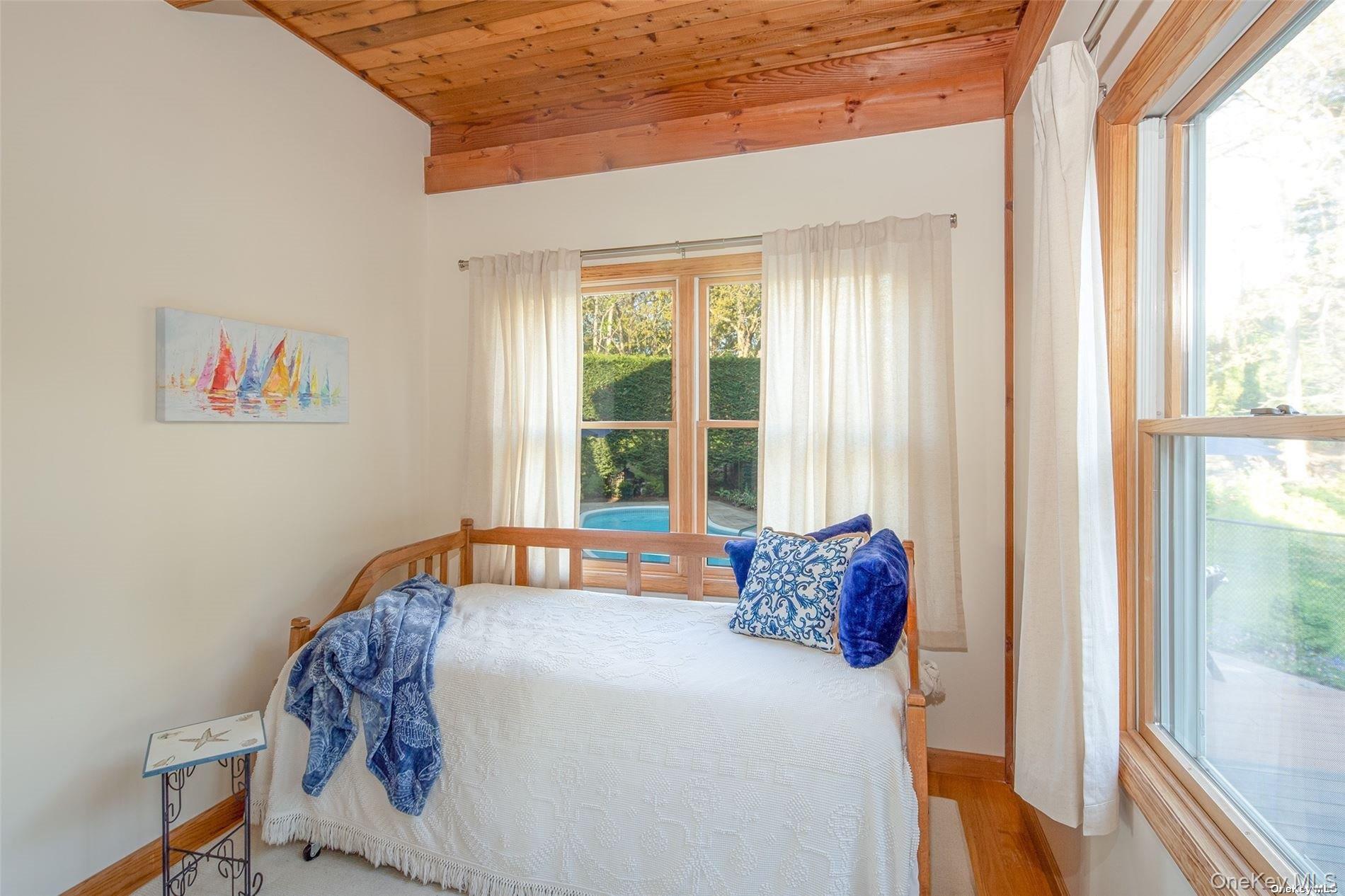 48 Oakhurst Road Hampton Bays, NY 11946 - Photo 15 of 25 a bedroom with a bed and a window