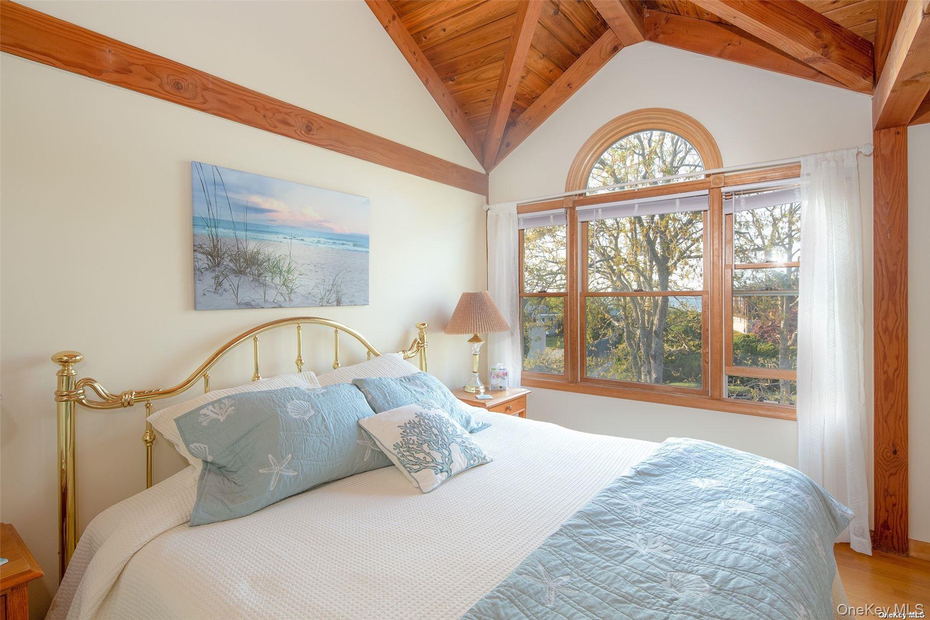 48 Oakhurst Road Hampton Bays, NY 11946 - Photo 16 of 25 a bedroom with a bed and a large window