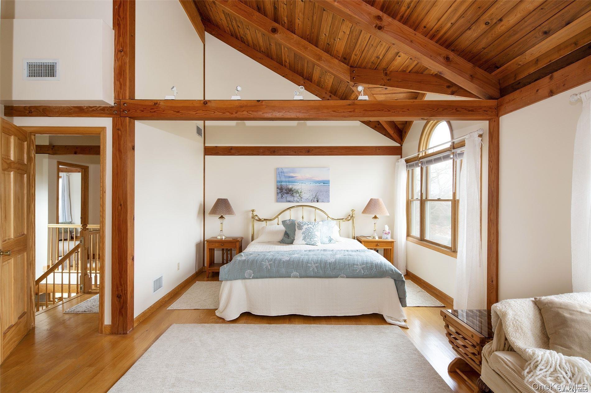 48 Oakhurst Road Hampton Bays, NY 11946 - Photo 17 of 25 a bedroom with a large bed and a window